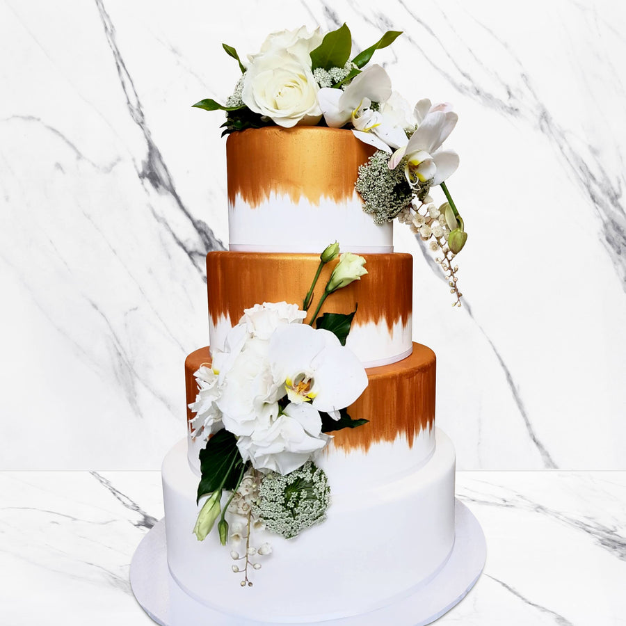 Fondant covered wedding cake with copper shimmer paint effect