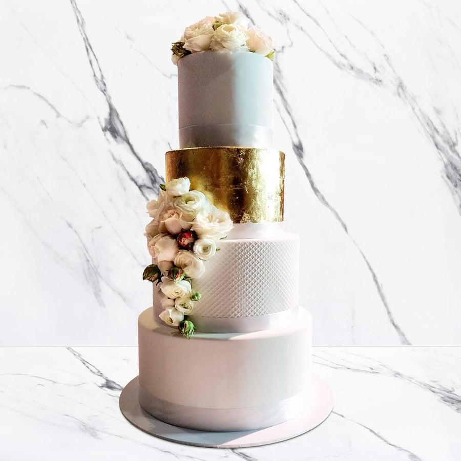 Fondant covered wedding cake – waffle cone detail with gold leaf tier