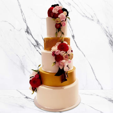 Fondant covered wedding cake with gold shimmer spray