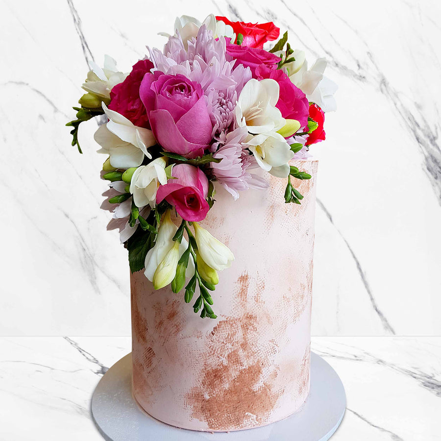 Nude cake coloured ganache with copper touches and fresh florals