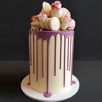 Royal purple drip cake with macaroons and fresh roses