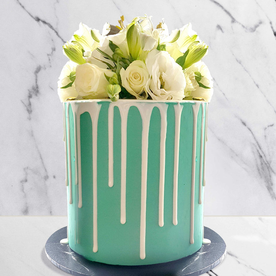 Tiffany blue cake with chocolate drip and fresh white florals