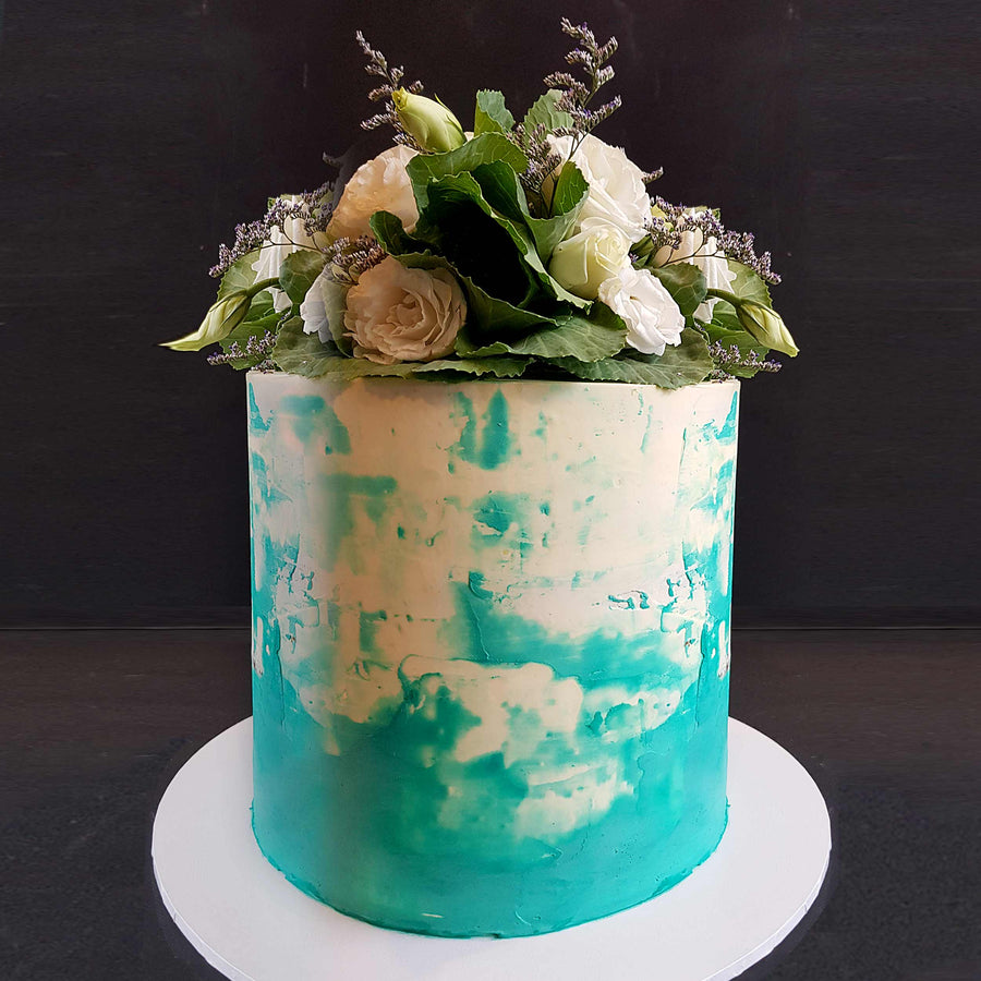 White and blue watercolour buttercream cake with fresh florals