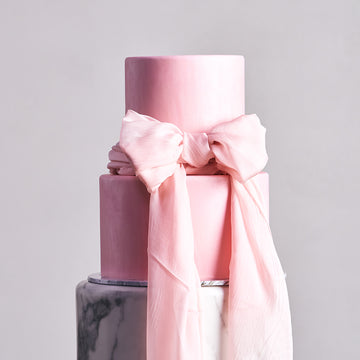 Fondant covered cake - 2 tier with soft pink design and elegant bow