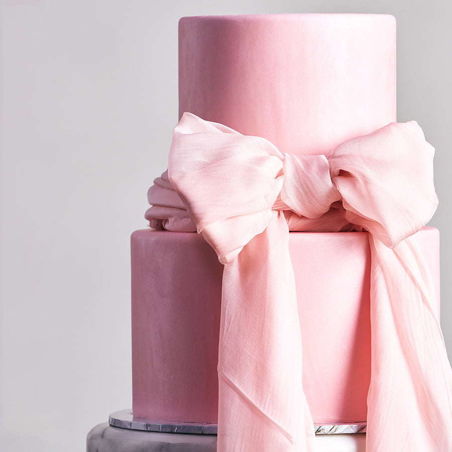 Fondant covered cake - 2 tier with soft pink design and elegant bow